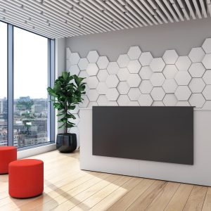 modern white reception counter with dark panel with hexagon panels on the wall in the background