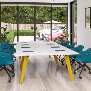 white boardroom type desk, with yellow legs and green chairs with green bases