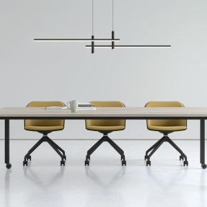 simple bench desk with black legs, castors and light wood top, yellow chairs with black frames