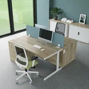 2 light brown desks with white trim, with integrated pedestal with white handles, white and black chair and green seat pad